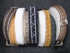 A box of nine spools of vintage Silver Cross pram trim