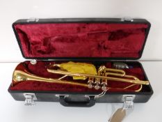 A cased Yamaha brass trumpet stamped YTR1335 409594