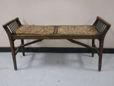 An antique pine rush seated folding duet stool