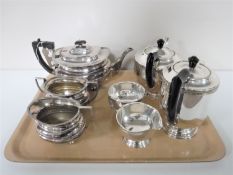 A tray of four piece plated Viners tea service and a three piece Cross Arrows plated tea service