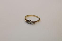 An 18ct gold three stone diamond ring, size O.