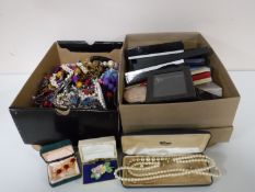A tray containing two boxes of assorted costume jewellery