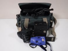A camera bag containing a Praktica BX20 camera, lenses, flash,