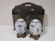 A metal magazine holder with armorial crest,