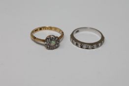 A white gold diamond half eternity ring and an 18ct gold diamond and opal cluster ring