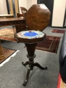 A Victorian walnut carved sewing box on stand