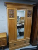 An Edwardian walnut mirror door wardrobe