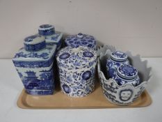 A tray of decorative china blue and white caddies, storage jars,