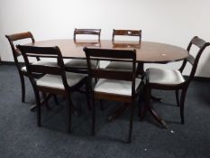 A regency style mahogany twin pedestal dining table and six chairs