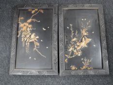 A pair of Japanese panels in relief decorated with birds