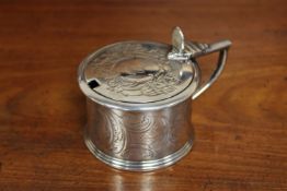A Georgian drum mustard pot with ornate design and family crest, with blue glass liner,