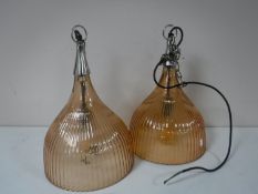 A set of four glass pendant light fittings