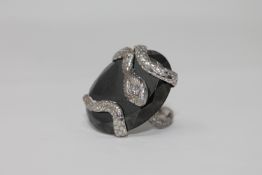 An unusual 18ct white gold and diamond set snake ring