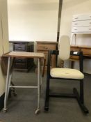 A contemporary rocking chair and a teak lap table