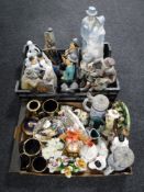 Two boxes containing china ornaments, Laurel and Hardy figures on bench, continental figures,