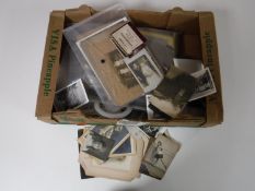 A large box containing monochrome photographs, vintage cards monochrome images,