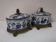 A pair of ormolu mounted blue and white oval lidded caskets