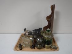 A tray of brass ornaments, miniature miners lamp, a metal ornament of a farmer, wooden stand,