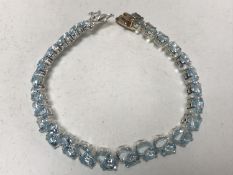 A silver and faux aquamarine bracelet