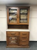 An early 20th century and later kitchen cabinet with melamine top and advertising decoration 