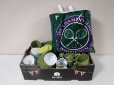 A box containing Melaware green and white plates, cups, etc,