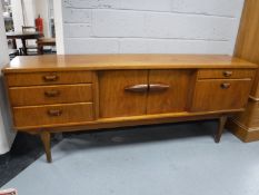 A teak mid 20th century low sideboard