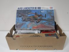 A box containing toys, die cast locomotives, aeroplane, hurricane,