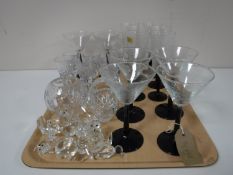 A tray of cocktail glasses, crystal animal ornaments,