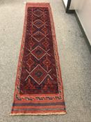 A Meshwani runner on red ground,