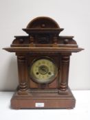 An Edwardian pine mantel clock with enamel dial