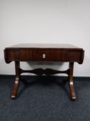 An antique mahogany sofa table