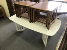 Two nests of teak tables and a white low table