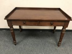 A Victorian mahogany two drawer writing table