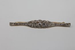 An 18ct gold diamond set bar brooch