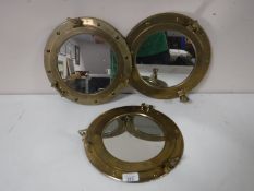 Three brass porthole style mirrors