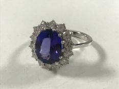 An 18ct white gold tanzanite diamond cluster ring, size N/O.
