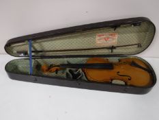 A Stradivarius copy violin and two bows in wooden case