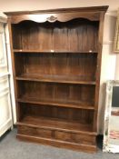 A large hardwood bookcase fitted with four drawers