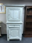 A French painted white cabinet on stand fitted with a drawer