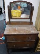 An early twentieth century oak two drawer dressing table