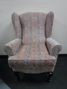An upholstered wing armchair