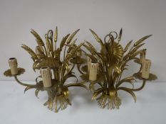 A set of three gilt metal light fittings.