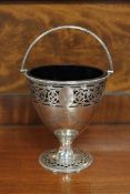 An ornate George III silver sugar basket, with family crest, blue glass liner, maker W P,