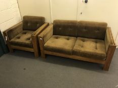 A mid 20th century oak framed settee and matching armchair