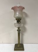 A Victorian glass oil lamp with clear glass reservoir