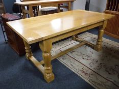 A high quality light oak refectory table