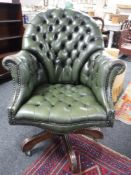 A green leather Chesterfield office chair