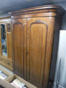 A Victorian mahogany bow fronted double door wardrobe