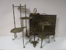 Two brass tiered stands together with a brass ashtray on stand and a brass firescreen