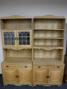 A two section light oak bookcase with drawers and cupboards below